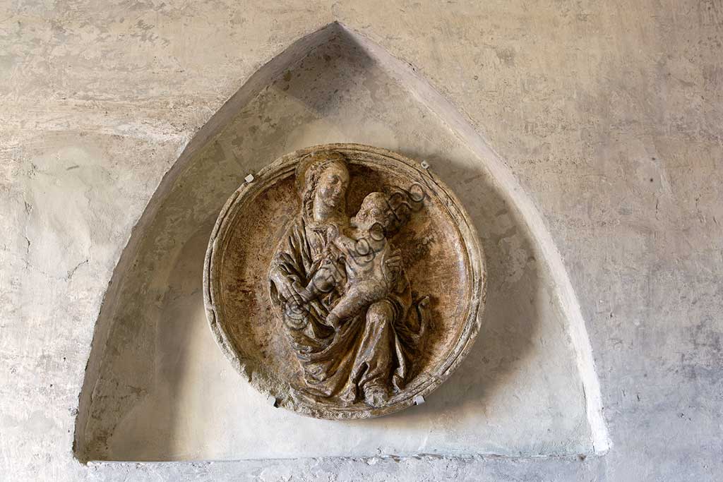 Vignola Stronghold, the niche above the door to the Contrari Chapel:  a tondo in scagliola (fifteenth-century style), depicting a Madonna with Child, in the variant called Madonna of Humility.