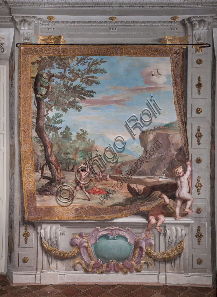 Sassuolo, Este Ducal Palace, the Bacchus Gallery: "Bacchus fighting with the snake sent to him by Juno". The faux tapestry with the vast rocky landscape is lifted by a putto who remains partially hidden by it, while to the side, another putto holds onto the edge. In the foreground, left in front of a large tree, Bacchus strikes the snake that sent Juno against him with a vine branch. It is one of the forty-one panels with scenes painted by Jean Boulanger which narrate the events of Bacchus. Wall tempera painting, 1650 - 52.