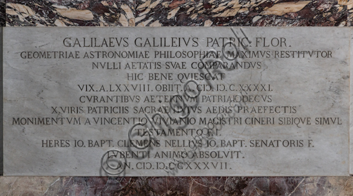 Basilica of the Holy Cross, left aisle: "Sepulchre of Galielo Galilei", 1734-7.Detail of theinscription on the basement.