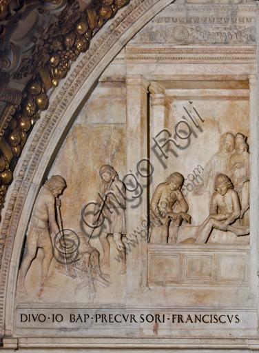 Genoa, Duomo (St. Lawrence Cathedral),the Chapel of St. John the Baptist, Western wall:  "St. John's burial", detail of the lunette with scenes of the life of St. John the Baptist (in the centre, the banquet of Herod and laterally the martyrdom and burial of the Baptist); bas-relief (stiacciato) in marble. The lunette was realised  by Giovanni d’Aria with the collaboration of the brothers Michele and Bonino in 1496.