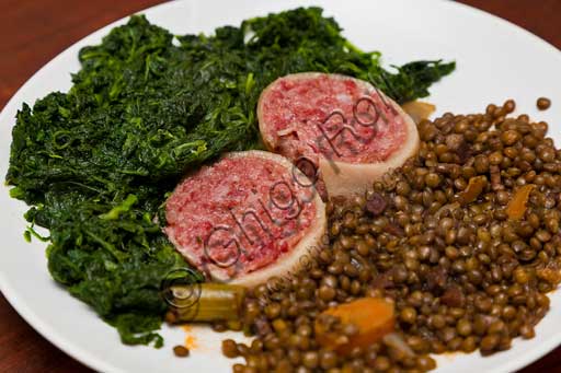 Typical Modena product: zampone (cold cut) served with spinach and lentils.
