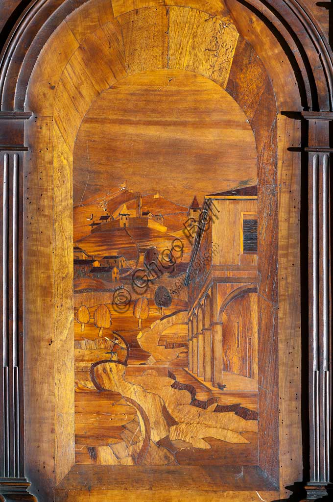 Basilica di San Prosperom Coro Ligneo: particolare di tarsia lignea di uno stallo, con prospettiva e paesaggio, di Cristoforo e Giuseppe De Venetiis (1545 - 1546).