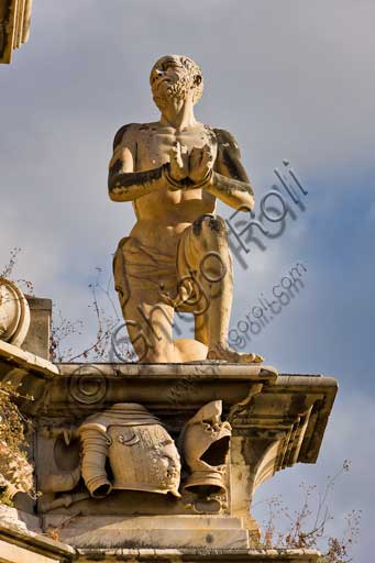 Palermo, Piazza del Parlamento:  il "Teatro Marmoreo",  monumento a Filippo V, prospiciente Palazzo Reale (o "dei Normanni"). Gruppo scultoreo monumentale, è opera dello scultore Gaspare Guercio, di Carlo D'Aprile e Gaspare Serpotta, realizzato per celebrare la gloria di Filippo IV d'Asburgo, re di Spagna e di Sicilia, detto Filippo il Grande. Intorno al piedistallo furono disposte le raffigurazioni delle quattro parti della Terra note a quei tempi (Europa, Asia, Africa e America), sulle quali il re di Spagna governava. Sul primo livello furono poste le statue dei quattro Mori, ovvero dei precedenti re dei Paesi andati sotto la sua dominazione. L'opera è adornata da targhe e stemmi dei maggiori casati della Sicilia. L'originaria statua di Filippo IV andò distrutta durante la rivoluzione siciliana del 1848 e fu sostituita nel 1856 dalla statua attuale in marmo che rappresenta il re Filippo V di Spagna e fu eseguita da Nunzio Morello.Particolare con statua di Moro imprigionato.