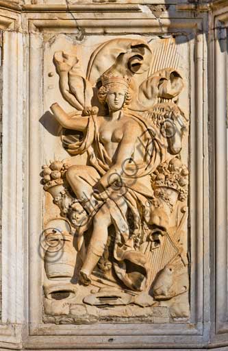 Palermo, the Parliament Square: The Marble Theatre, monument to Philip V, facing The royal Palace or Palace of the Normans. It was realised by Gaspare Guercio, Carlo D'Aprile and Gaspare Serpotta to celebrate the glory of Philip IV of Habsburg, king of Spain and Sicily, called Philip the Great.Around the pedestal  the four parts of the Earth known at that time (Europe, Asia, Africa and America), on which the king of Spain ruled, are depicted. On the first level there are the statues of the four Moors, or the previous kings of the countries that went under his domination. The work is adorned with plaques and coats of arms of the most important families in Sicily. The original statue of Philip IV was destroyed during the Sicilian revolution in 1848 and was replaced in 1856 by the current marble statue representing King Philip V of Spain and was realised by Nunzio Morello.Detail.