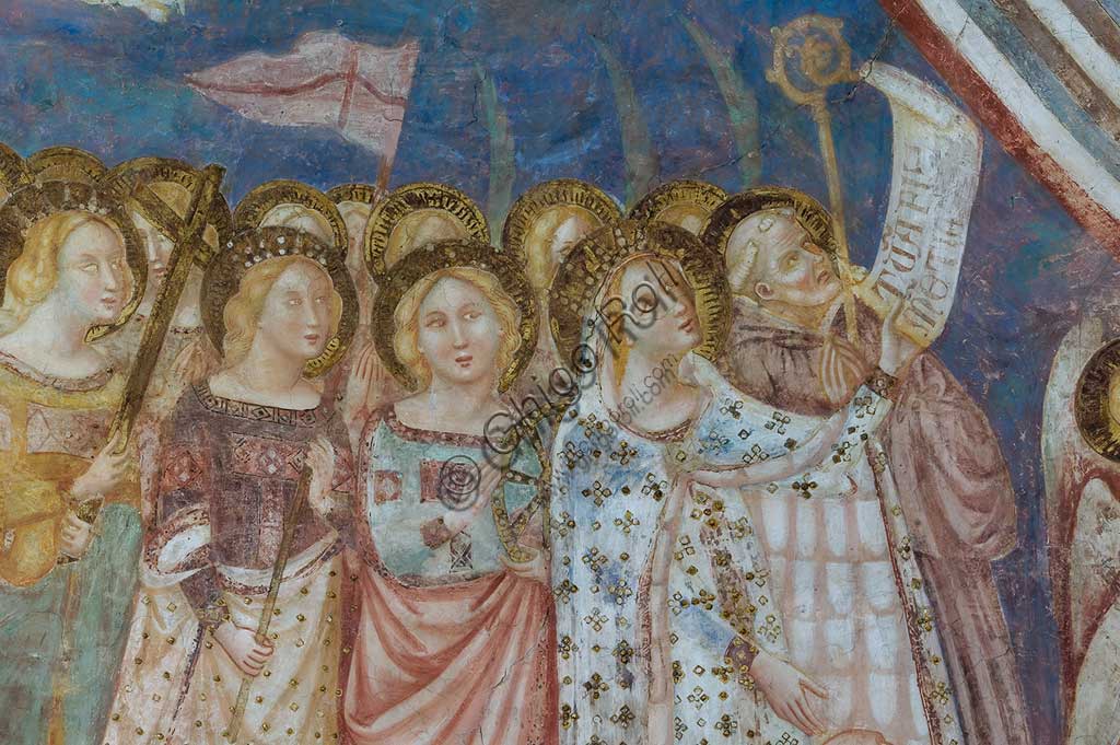 Codigoro, the Pomposa Abbey, interior of the Basilica of Santa Maria, apse: fourteenth-century frescoes by Vitale da Bologna. Detail of the Virgin Mary, depicted in a precious gold embroidered dress, while presenting the patron abbot Andrea. She holds the cartouche with the inscription "tuam fili clementiam" in her left hand. The latin text is a recommendation for the community of Pomposa and for humanity. Next to her, the holy Benedictine is Guido, while in the foreground there are the saints Caterina, Orsola, Elena and Maddalena.