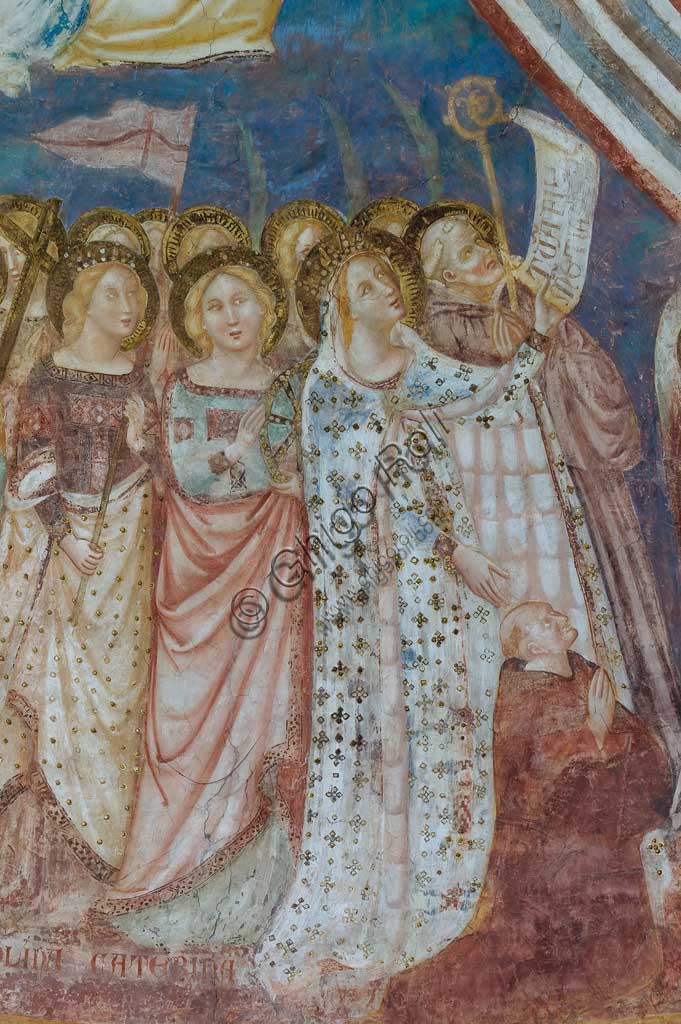 Codigoro, the Pomposa Abbey, interior of the Basilica of Santa Maria, apse: fourteenth-century frescoes by Vitale da Bologna. Detail of the Virgin Mary, depicted in a precious gold embroidered dress, while presenting the patron abbot Andrea. She holds the cartouche with the inscription "tuam fili clementiam" in her left hand. The latin text is a recommendation for the community of Pomposa and for humanity. Next to her, the holy Benedictine is Guido, while in the foreground there are the saints Caterina, Orsola, Elena and Maddalena.