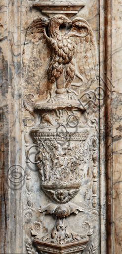 The Piccolomini Library, the exterior marble façade, pilaster: detail of a vase with an eagle with spread wings and a scene of fight between Hercules and Antaeus by Lorenzo di Mariano Fucci, known as Marrina.