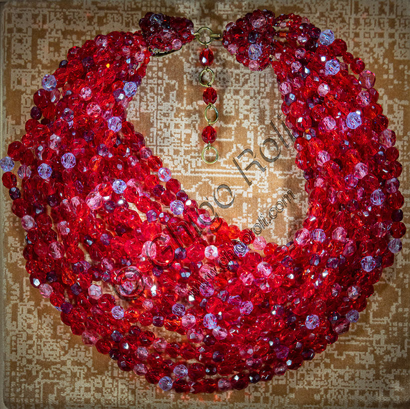 Vicenza, Jewellery Museum,  room Fashion: multi strand bead necklace attributed to EMILIO PUCCI, designed by Lyda Coppola; early 2960s; strung fire polished faceted glass beads in several shades of red.