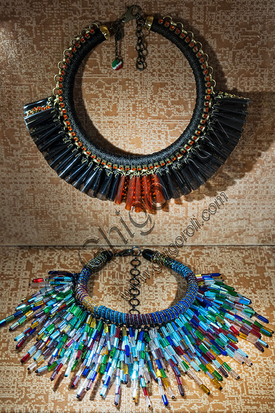 Vicenza, Jewellery Museum,  room Fashion: above, necklace by Sveva Camurati; 2016; pvc pleated by hand and mounted on brass chain, Swarovski rhinestones, aluminum chain. Below, Necklace, di Sharra Pagano, Fireworks Collection, 2018; glass, crystals.