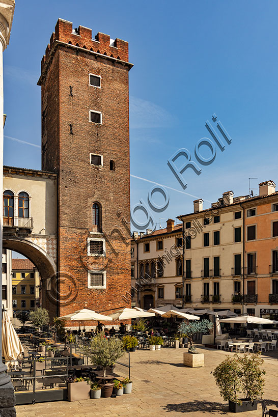 Vicenza, Delle Erbe Square:  bar and restaurant tables. In the background, the medieval Girone Tower, due to the moat that surrounded it, or the Torment Tower, because it was later used as a prison.